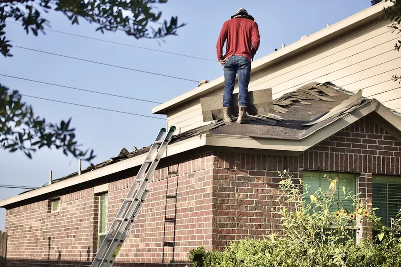 Professional roofer working on a residential roof in Chevy Chase View